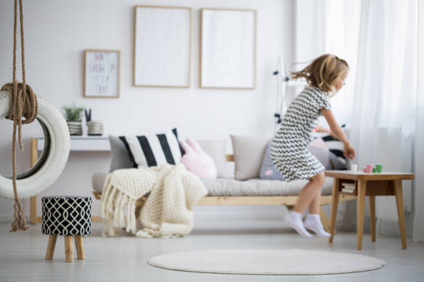 istock Girl jumping in room 834560220