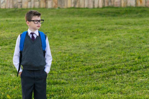 istock Schoolboy with a backpack looking at the place for your inscription 834572542