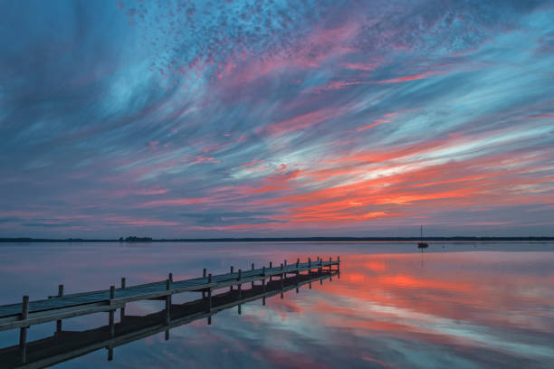 istock Majestic cloudscape at dusk with reflection on lake 834573450