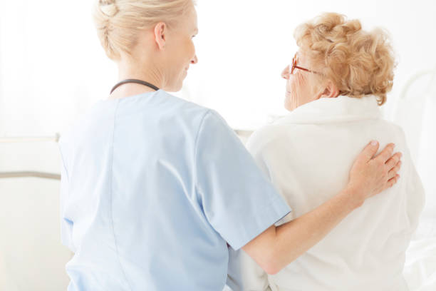 istock Nurse sitting on a hospital bed 834574154
