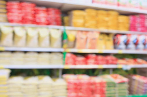supermarket with rice shelves blur background