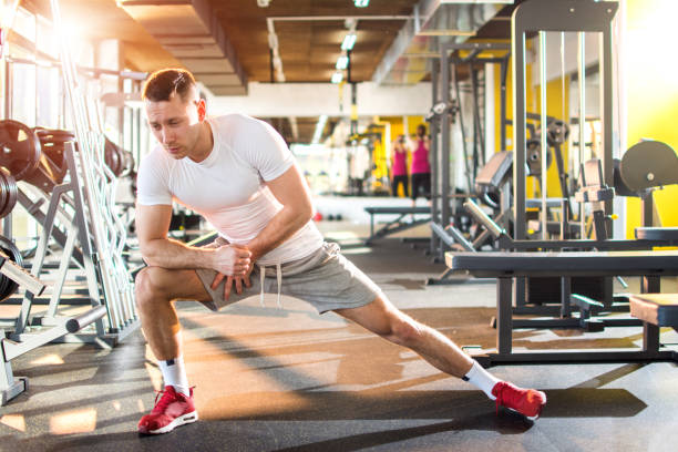 istock Young athletic man stretching in gym. 834601538