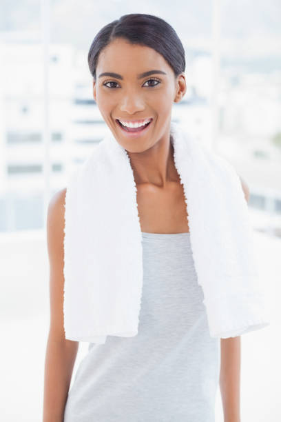 istock Cheerful sporty model with towel on shoulders posing 834607326