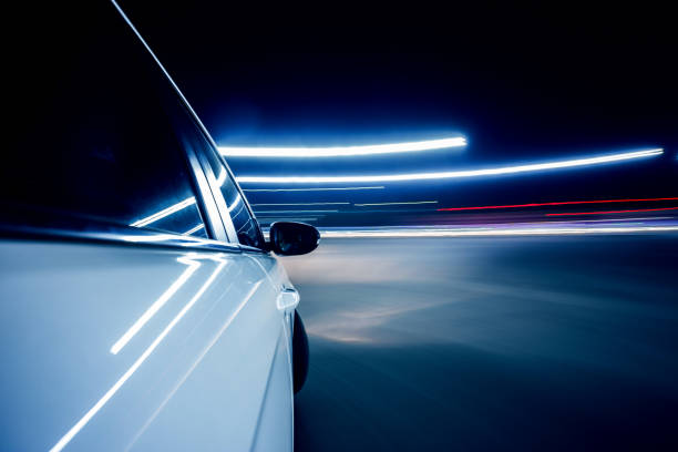 istock Speeding car driving at night 834610634