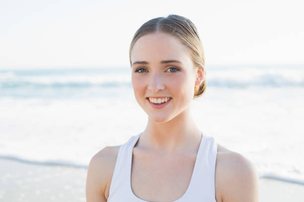 istock Content young brunette woman sitting on the beach 834620466