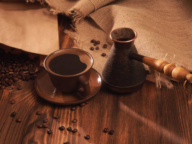 istock Coffee cup on a wooden backgound. 834623296