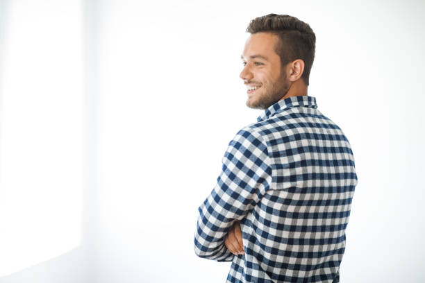 Side view portrait of smiling handsome man on white background