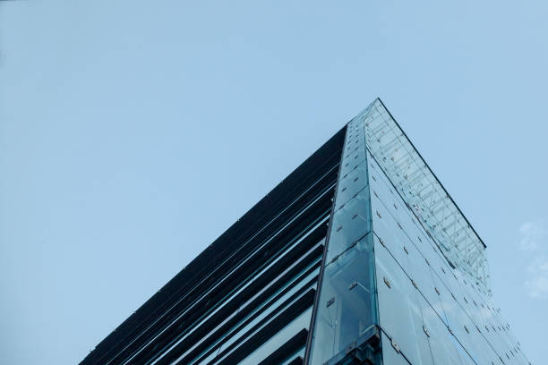 istock Corner of a skyscraper under a cloudy and cold sky seen from the bottom 834641688