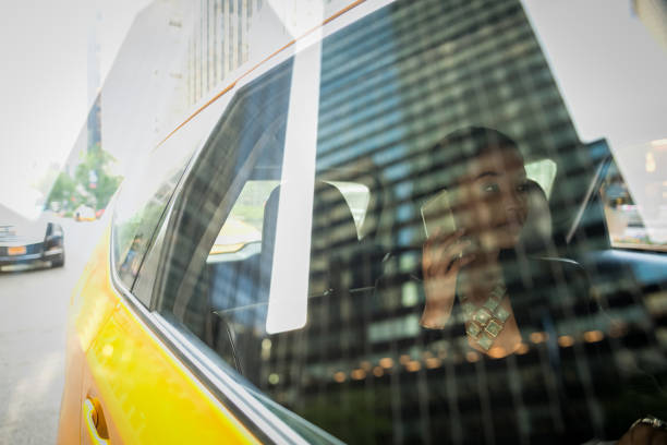 Double exposure of a businesswoman on the phone in a New York taxi