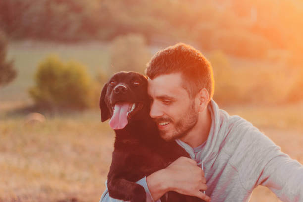 istock Rear view of a young man hug his dog 834703802