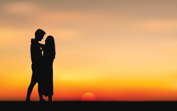 istock Silhouette couple man kissing woman under sunset sky background 834705992