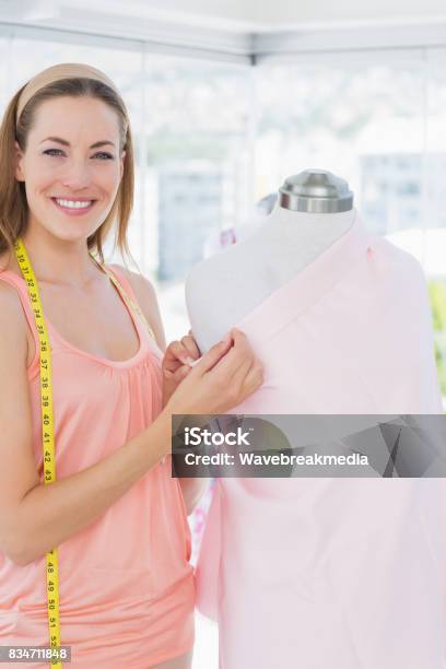 Female Fashion Designer Working On Pink Fabric Stock Photo - Download Image Now - 30-34 Years, 30-39 Years, Adult