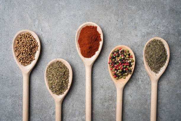 istock Fresh herbs and spices on wooden spoons. 834712284