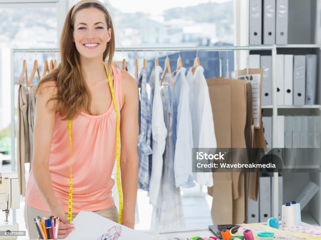 Smiling female fashion designer working in studio Portrait of a smiling beautiful female fashion designer working in studio 30-34 Years Stock Photo