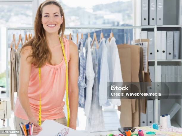 Smiling Female Fashion Designer Working In Studio Stock Photo - Download Image Now - 30-34 Years, 30-39 Years, Adult