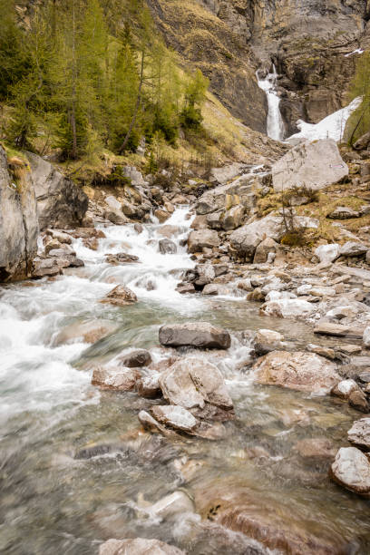 istock Waterfall and stream, Swiss alps 834713868