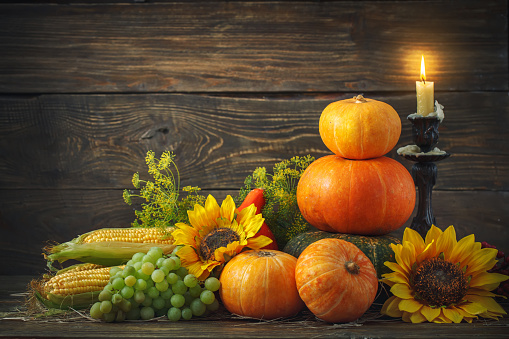 Happy Thanksgiving Day background, wooden table, decorated with vegetables, fruits and autumn leaves. Autumn harvest festival.