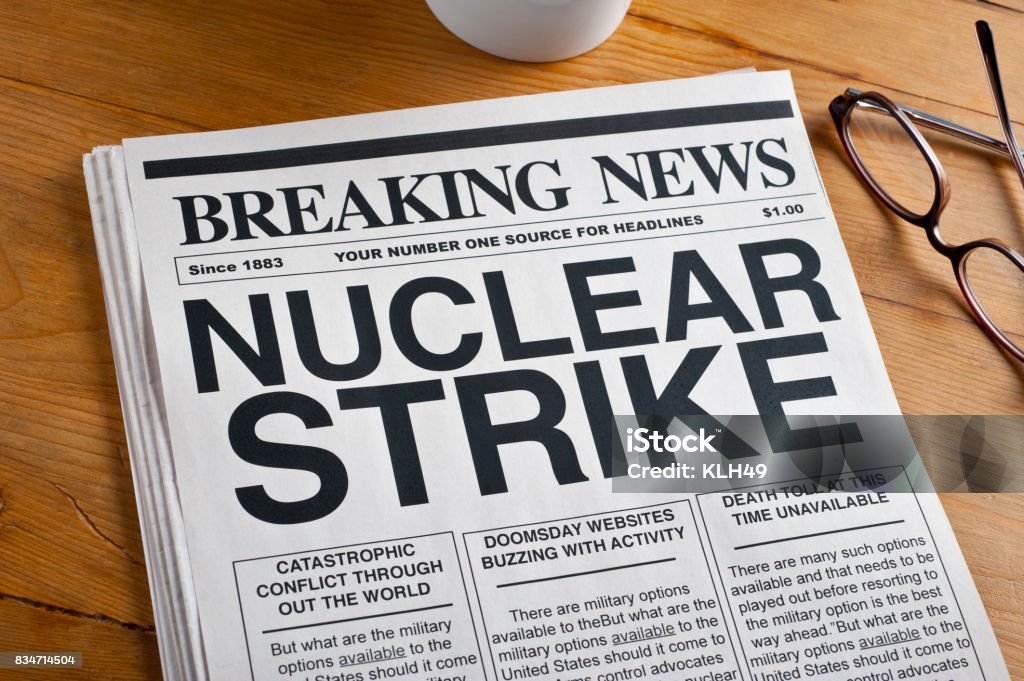 "Nuclear Strike" headline on a newspaper Newspaper with NUCLEAR STRIKE on a desktop. Air Pollution Stock Photo