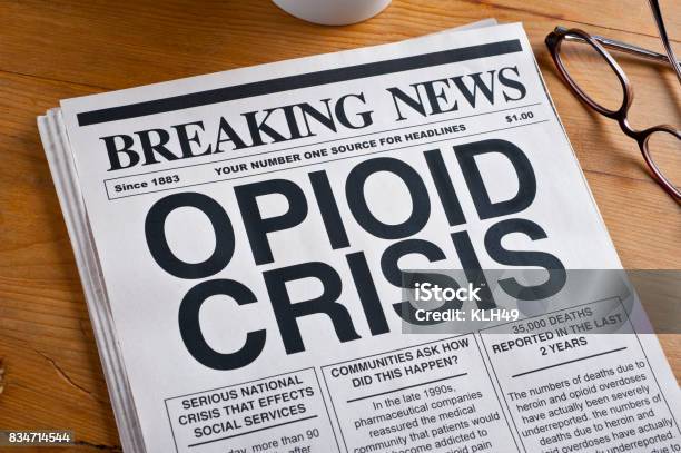 Opioid Crisis Newspaper Headline Newspaper Is On A Desk Stock Photo - Download Image Now