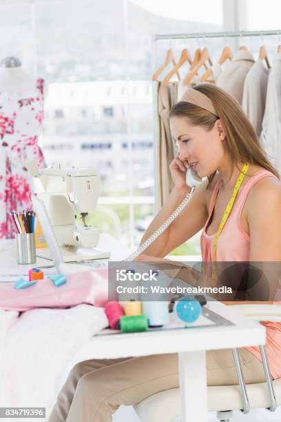 Young Female Fashion Designer Using Phone Stock Photo - Download Image Now - 30-34 Years, 30-39 Years, Adult