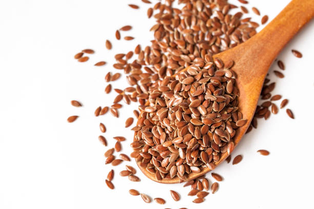 istock Flax seeds and spoon on white background 834721736