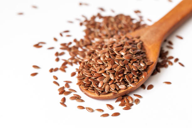 istock Flax seeds and spoon on white background 834721992