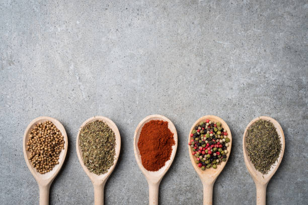 istock Fresh herbs and spices on wooden spoons. 834724470