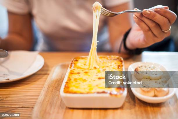 Woman Eating A Delicious Lasagna Stock Photo - Download Image Now - Cheese, Eating, Lasagna