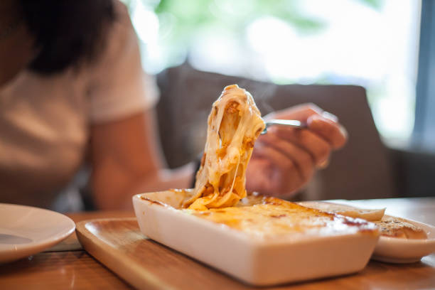 woman eating a delicious lasagna