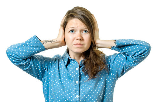 Young woman with closed ears isolated on white background