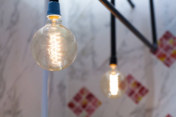 istock Incandescent lamps with tree in background. Edison lamp. 834730230