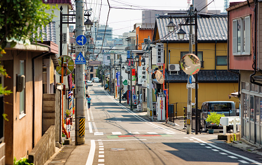 Small residential street in Nagano Japan with a few stores on each side.