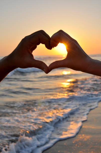 istock Young woman making heart shape with her fingers 834738128