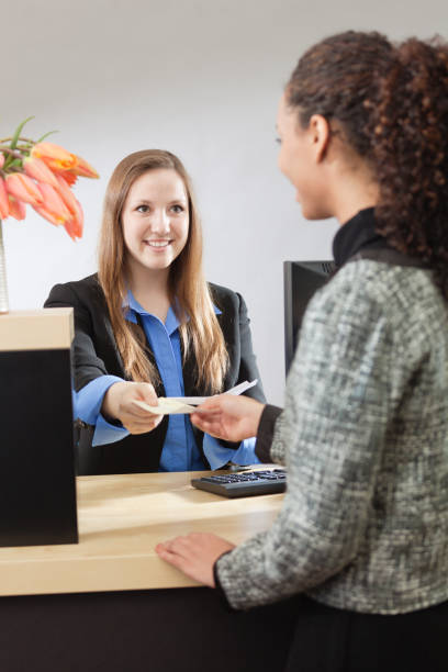 istock Bank Teller Working with Customer at Retail Bank 834751956