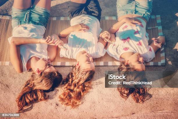 Teenage Girls Chilling Out At The Beach And Taking A Selfie Stock Photo - Download Image Now