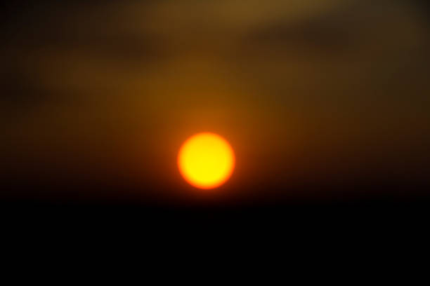 istock Sunset with sun and clouds in orange and golden light 834755466