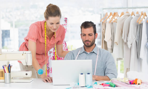 istock Fashion designers using laptop in bright studio 834759624