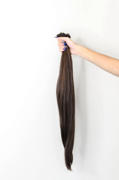 istock female hand holding hair 834760134