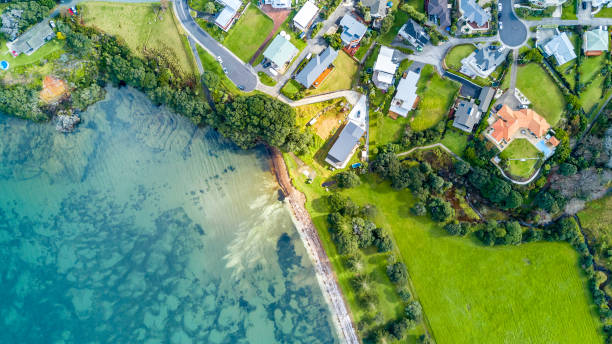 Aerial view on residential suburbs surrounded by sunny ocean harbour. Whangaparoa peninsula, Auckland, New Zealand Whangaparoa peninsula, Auckland, New Zealand new zealand photos stock pictures, royalty-free photos & images
