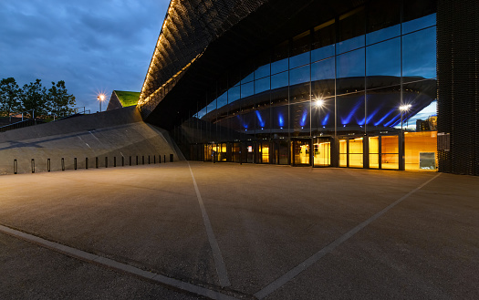 International Convention Centre in Katowice with Spodek in reflection in the evening.