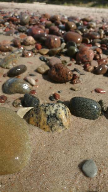 istock Colorful stones on sand 834764750