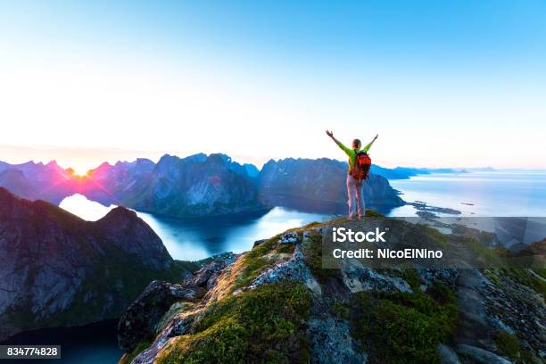 Hiker Enjoying Midnight Sun During Arctic Summer Reine Lofoten Norway Stock Photo - Download Image Now