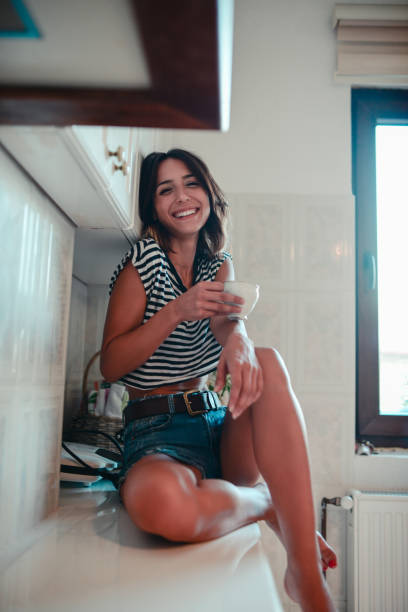istock Sensual Female Sitting on the Kitchen and Drinking Coffee 834775204