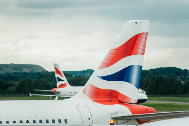 British Airways Airplanes Edinburgh, United Kingdom. 13 July 2017 - Two airplanes of British Airways, one of them parked and another one heading to the runway, at Edinburgh's Airport. british airways stock pictures, royalty-free photos & images
