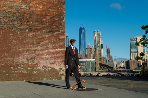 Businessman skateboarding  in New York City