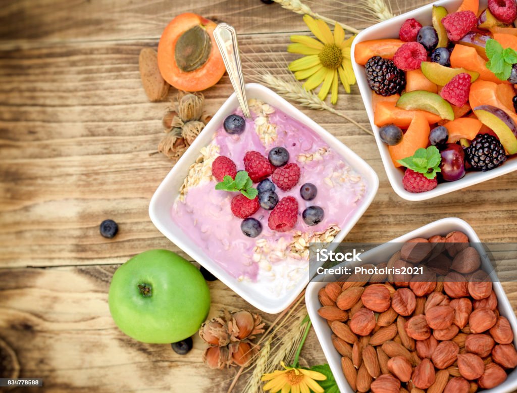 Vegetarian meal - oatmeal with fruit yogurt Vegetarian meal - oatmeal with fruit yogurt ( vegetarian food ) on rustic table Almond Stock Photo