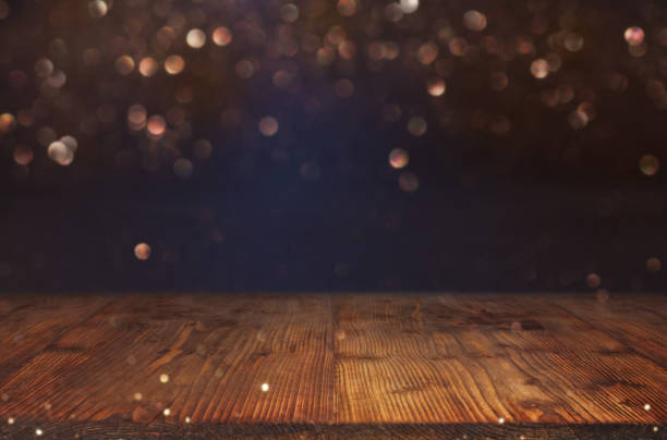 istock Abstract golden bokeh background with empty wooden table 834787854