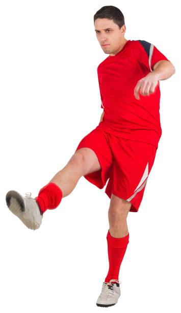 istock Fit young football player kicking 834789018