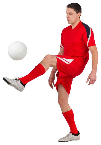 istock Fit young football player kicking 834789232