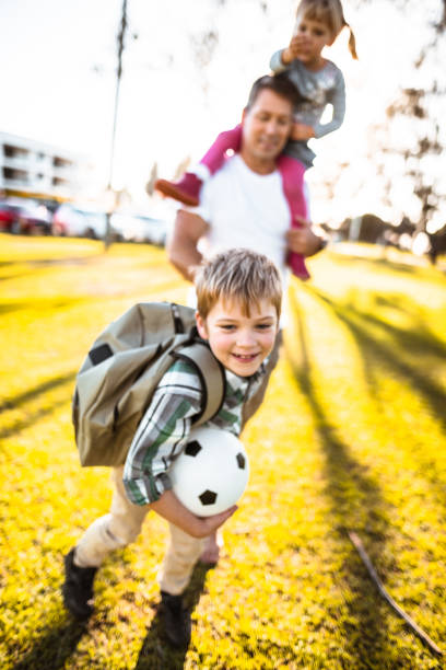 istock daddy take the son to the school 834791208